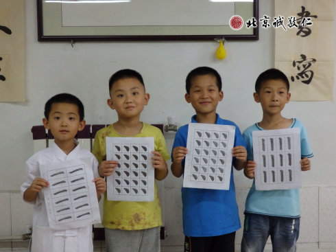 書法二班的小學員展示定心描紅習作